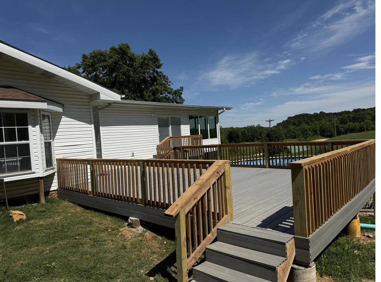 Residential deck with wood railing built in Poplar Bluff Missouri by Cheyenne Valley Construction